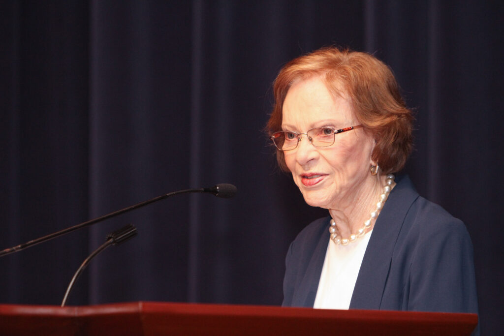 Former First Lady Rosalynn Carter speaks at the lectern of the 2016 Dorothy C. Fuqua lecture.