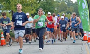 group of individuals run in a 5K race