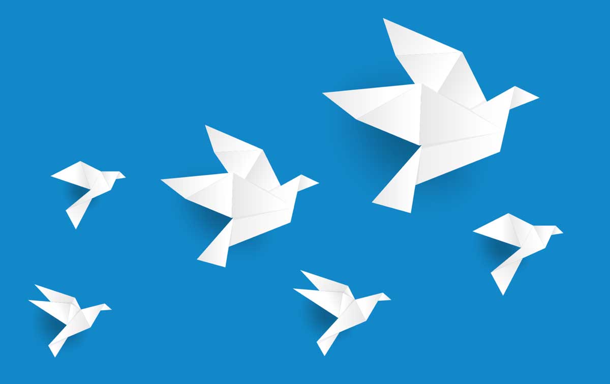 six white origami birds on a blue background