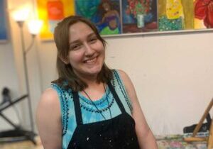 young woman smiling in art studio