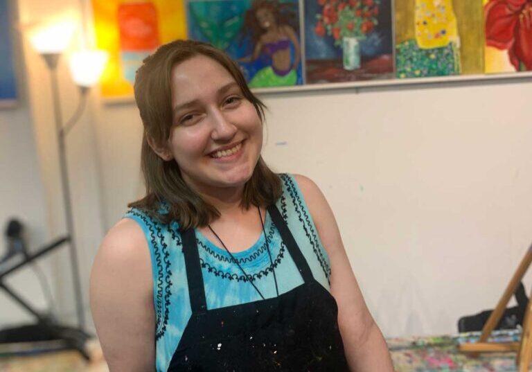 young woman smiling in art studio