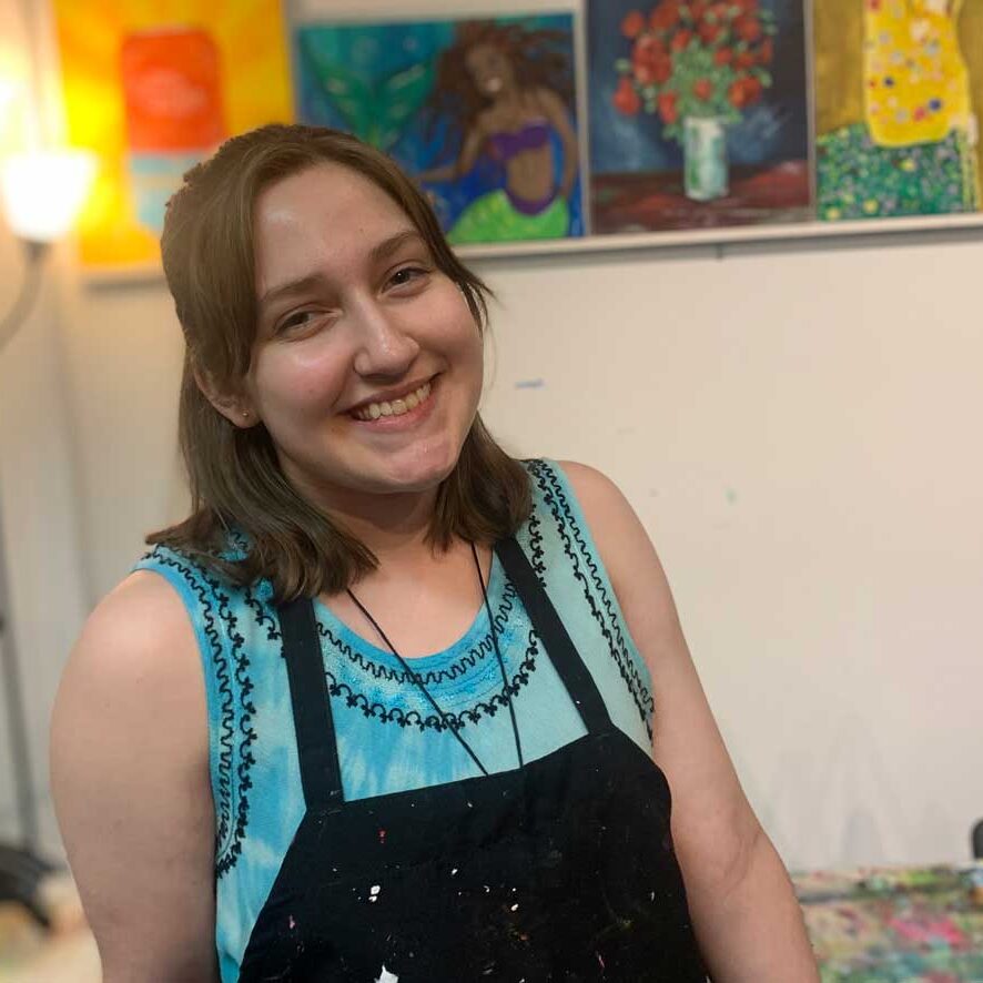 young woman smiling in art studio