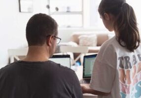 father helping teen daughter with her homework