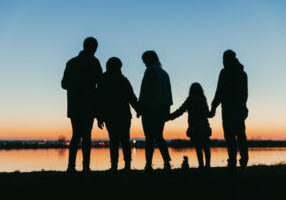 Silhouette of family at dusk on the beach
