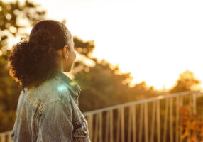 woman looking at sunrise